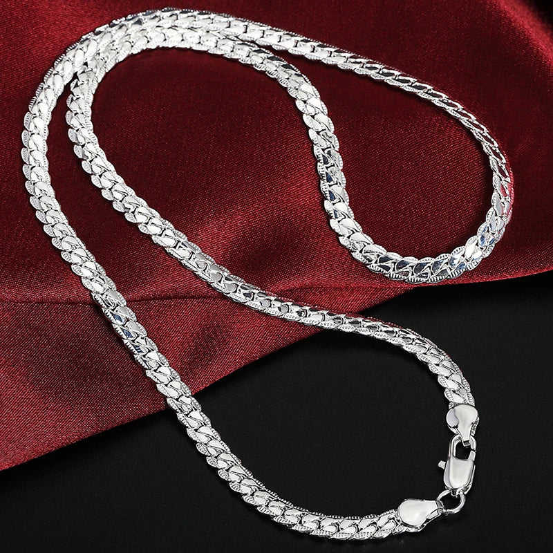 Fine Brands sterling silver jewelry set with necklace and bracelet, crafted by Corporación Turística, featuring elegant silver designs.