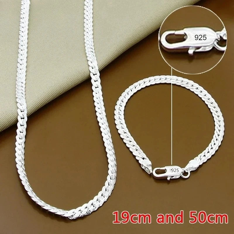 Fine Brands sterling silver jewelry set with a 18cm bracelet and 55cm necklace, featuring elegant silver designs.