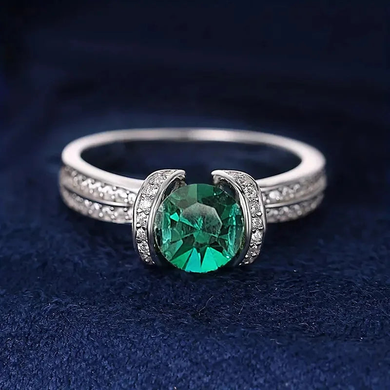 Sterling silver green cubic zirconia ring with band design, crafted by Corporación Turística.
