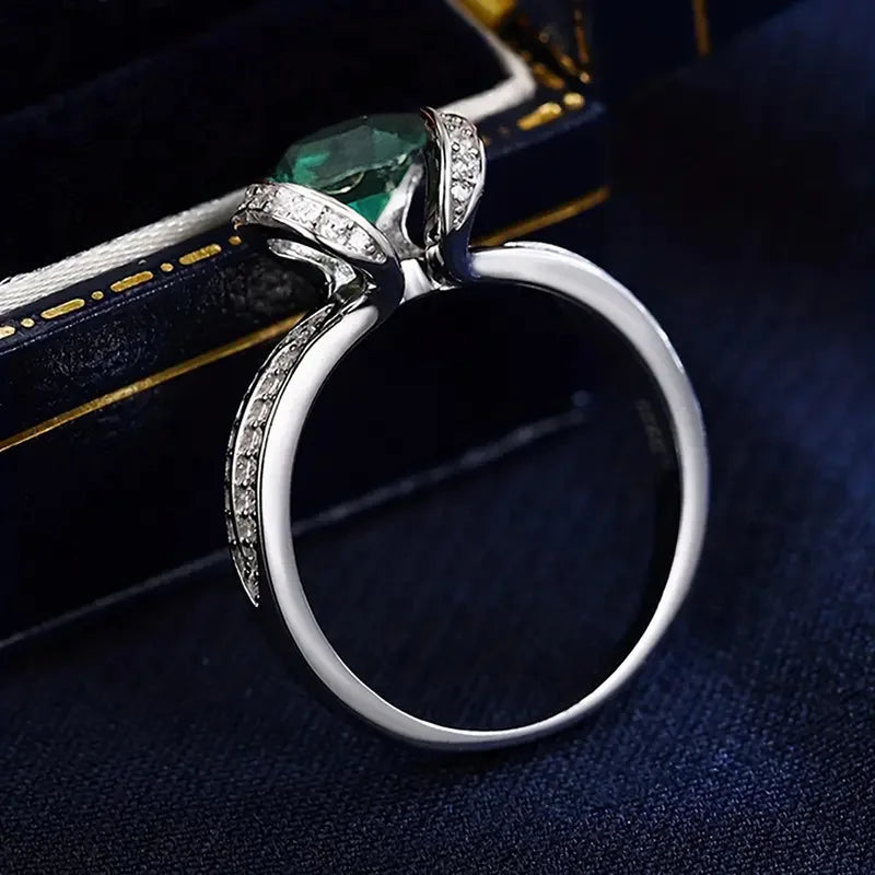 Sterling silver 925 green cubic zirconia ring with band design, showcasing sparkling gemstone and elegant craftsmanship.