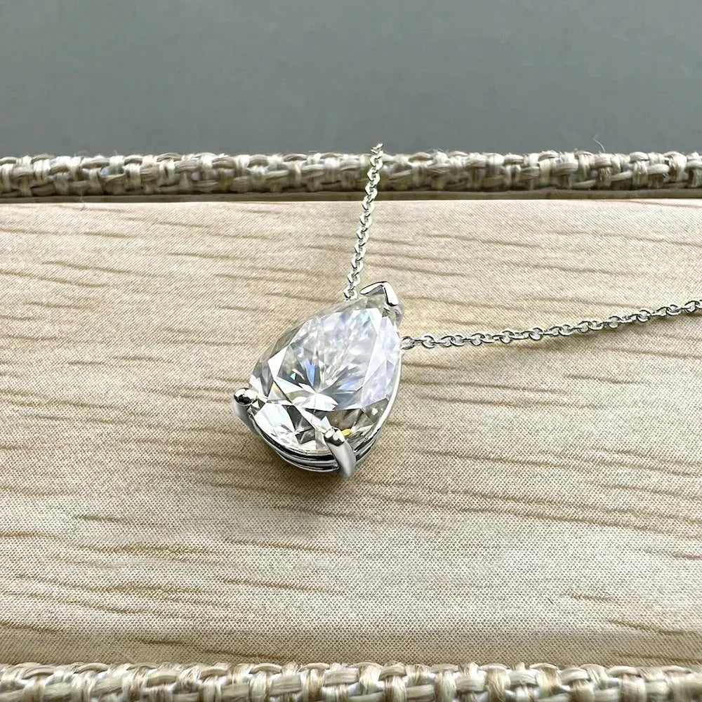 Silver moissanite drop pendant necklace with a teardrop-shaped gemstone, elegant jewelry piece for women.