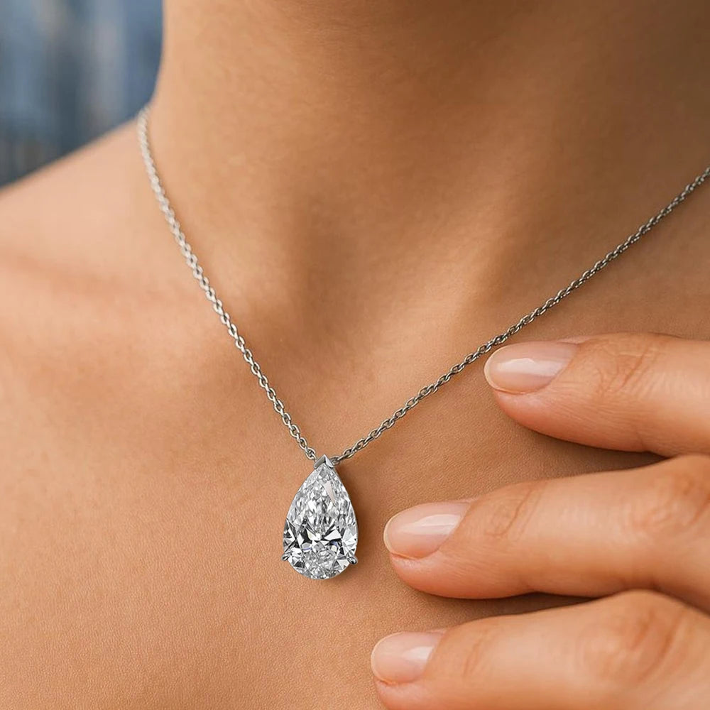 Silver moissanite drop pendant necklace featuring a teardrop-shaped gemstone, elegant jewelry piece with a sparkling, sophisticated look.