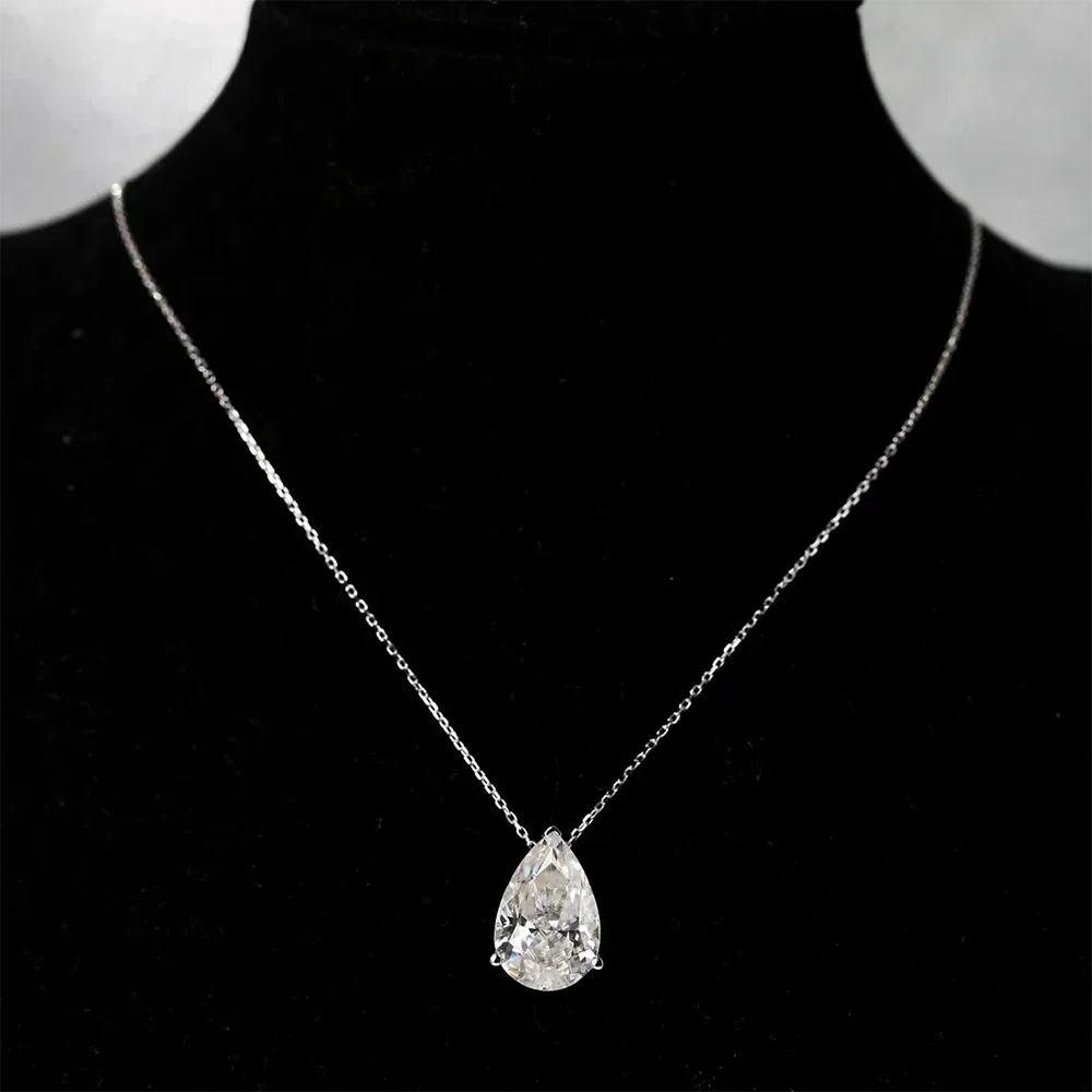 Silver moissanite pendant necklace with teardrop-shaped gemstone, featuring a delicate chain and elegant design.