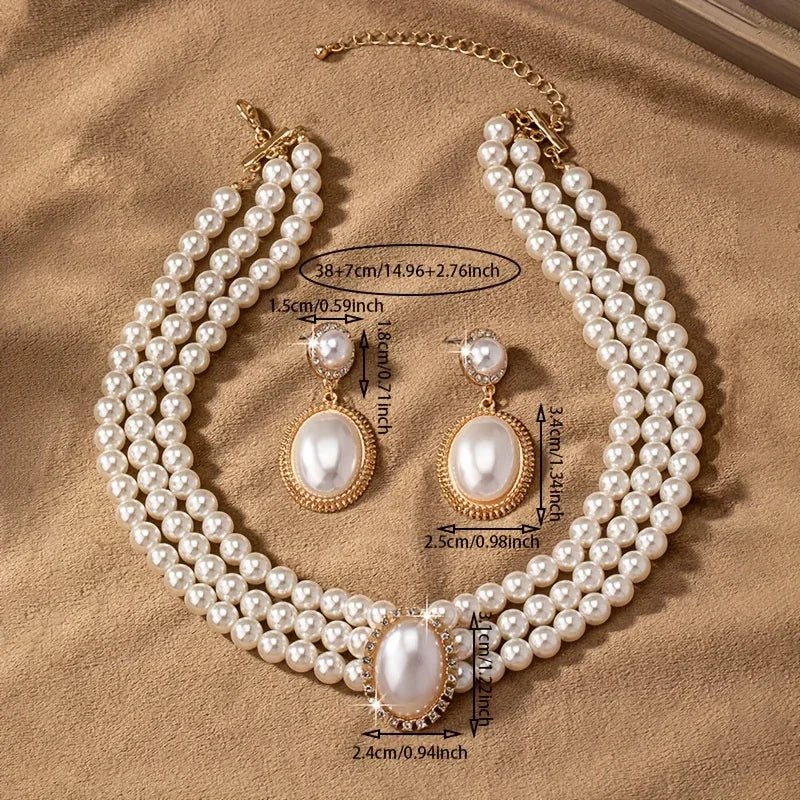 Set of elegant imitation pearl necklace and matching earrings with intricate design, perfect for formal occasions.