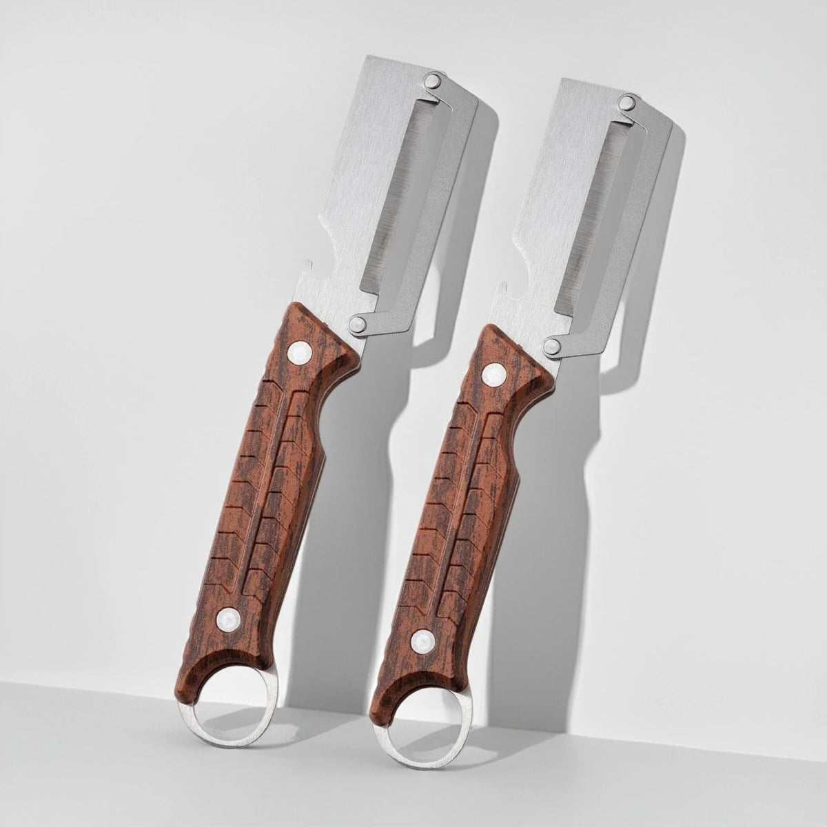 Stainless steel 3-in-1 onion chopper and peeler set by Corporación Turística, with sharp blades and ergonomic handles.