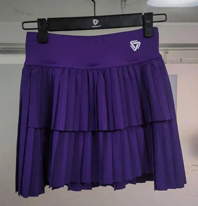 Mint green women's sports pleated mini skirt by Corporación Turística, designed for tennis and active wear.