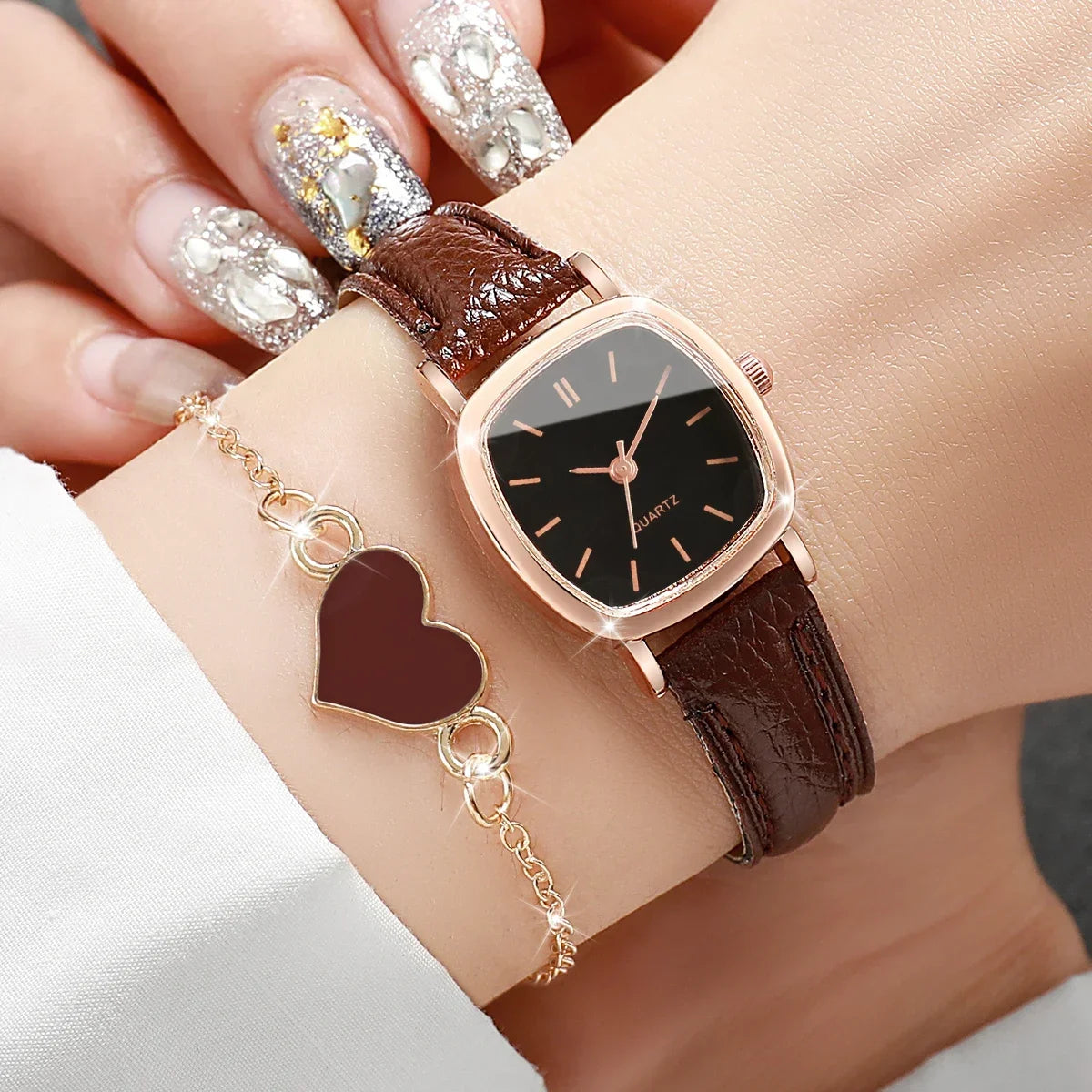 Two rose gold square quartz women's watches with elegant dials, branded by Corporación Turística, displayed side by side.
