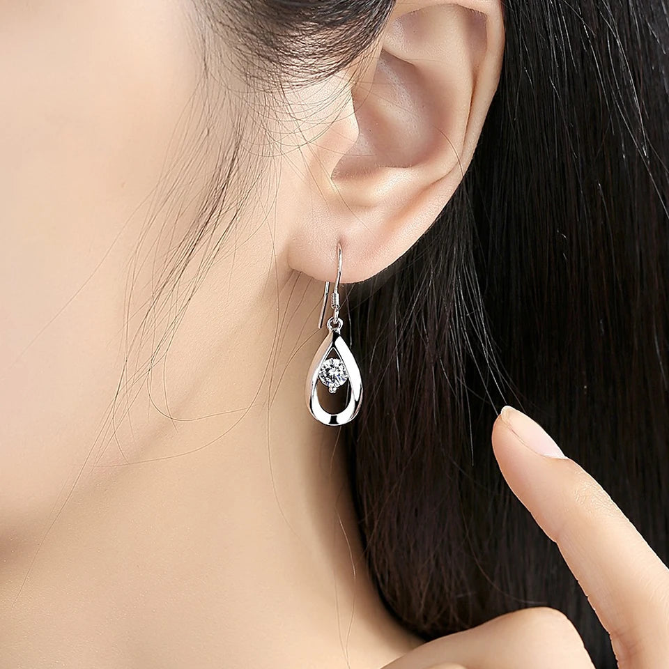 Water drop-shaped cubic zirconia earrings for women, silver-tone dangling jewelry with sparkling stones.