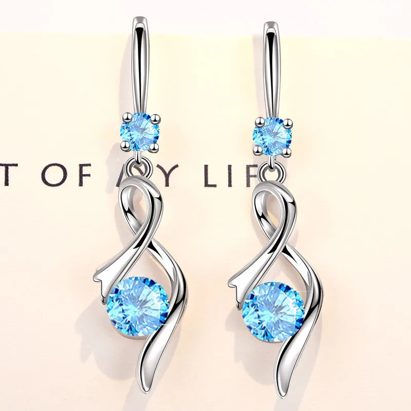 Water drop-shaped zircon earrings for women, silver-tone jewelry with sparkling stones, elegant dangling earrings for formal or casual wear.
