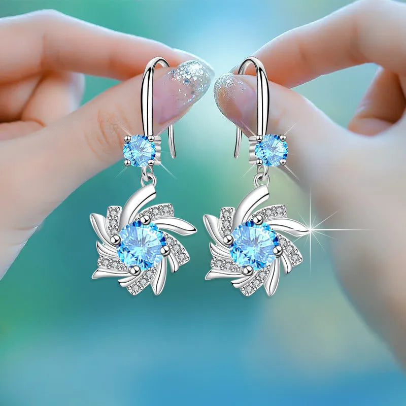 Water drop-shaped zircon earrings for women, silver-tone dangling earrings with sparkling stones, stylish jewelry accessory.