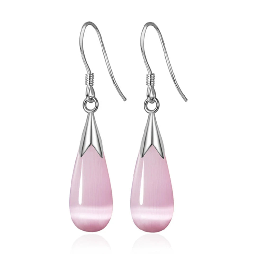 Water drop-shaped zircon earrings for women featuring sparkling clear stones, elegant dangle design, by Corporación Turística.