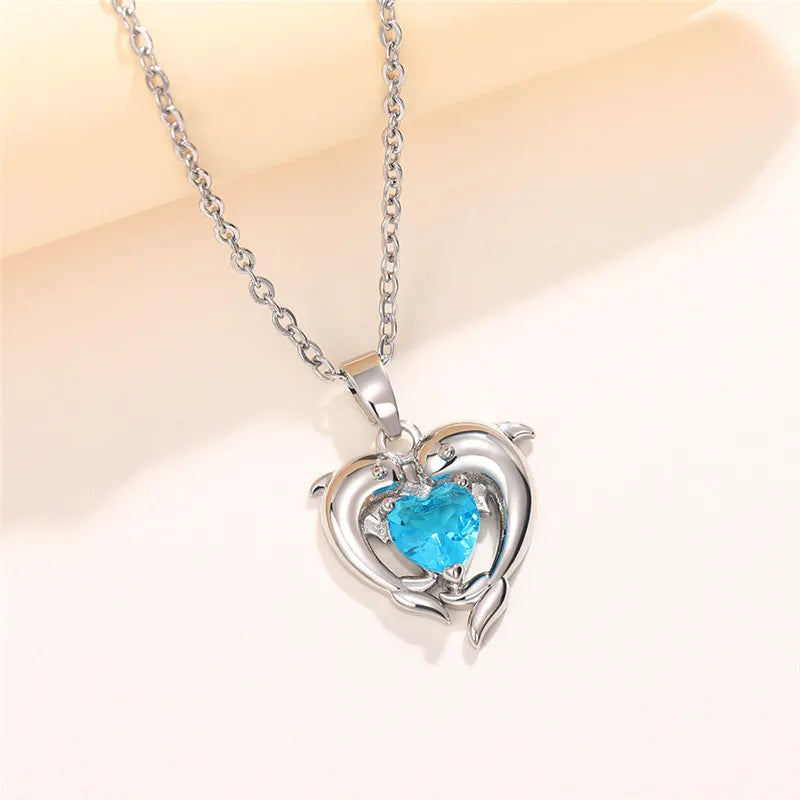 Sterling silver 925 dolphin and heart-shaped necklace by Corporación Turística, featuring detailed dolphin and heart charms.