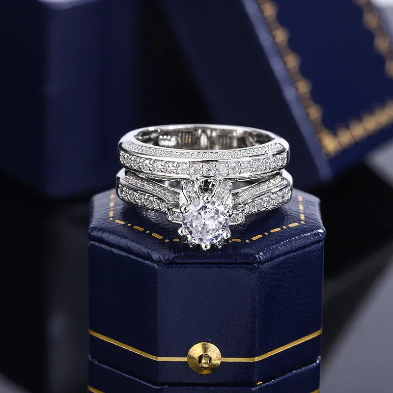 Set of high-quality crystal zircon wedding rings by Corporación Turística, featuring elegant silver bands with sparkling stones.