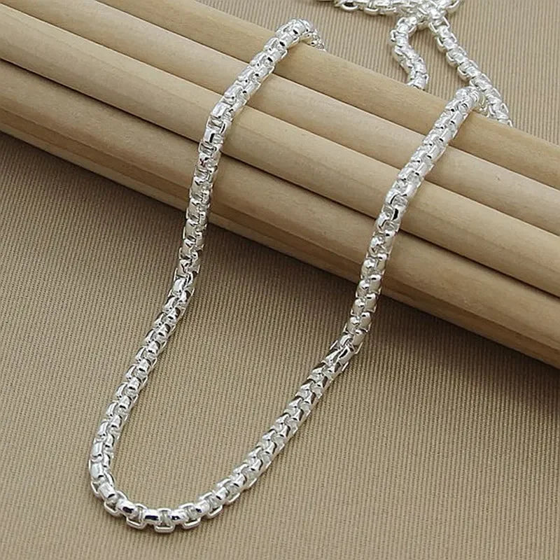 Wholesale 45-60cm sterling silver 925 chain from Corporación Turística, 4mm wide with a box clasp, in a product image.