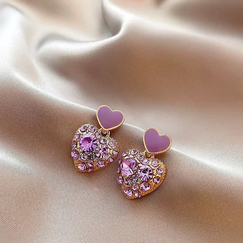 Purple crystal heart drop earrings for women, elegant jewelry from Corporación Turística with sparkling gemstone details.