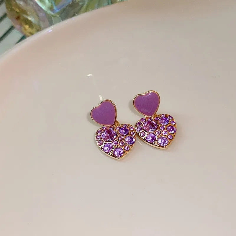 Purple crystal heart drop earrings for women, featuring elegant dangling design from Corporación Turística.