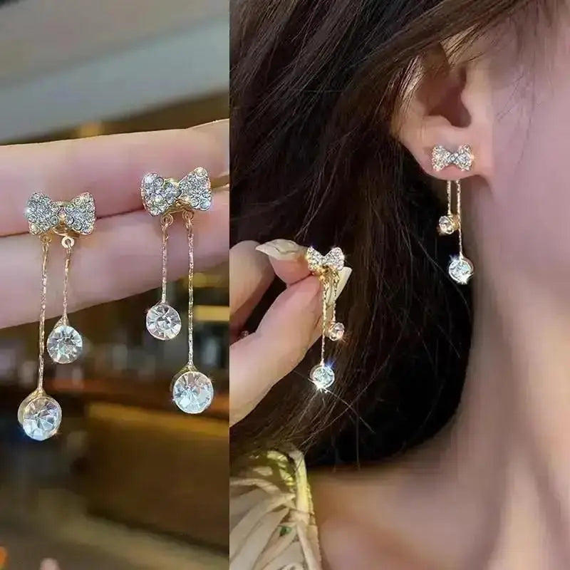 Purple crystal heart drop earrings for women, featuring elegant teardrop design from Corporación Turística.