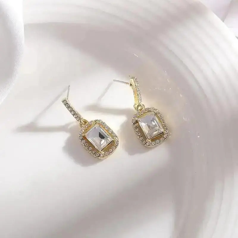 Purple crystal heart drop earrings for women, featuring elegant teardrop design by Corporación Turística.