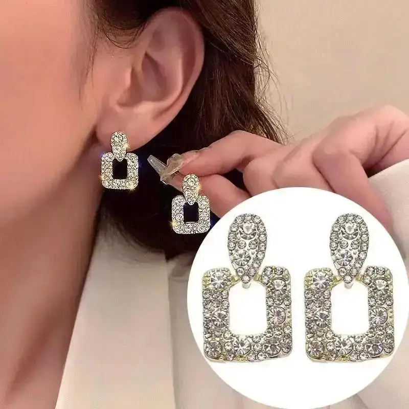 Purple crystal heart drop earrings for women, featuring elegant jewelry design from Corporación Turística.