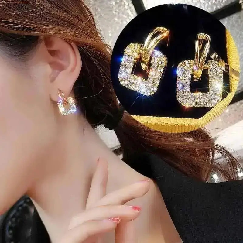 Purple crystal heart drop earrings for women, featuring elegant teardrop design from Corporación Turística.