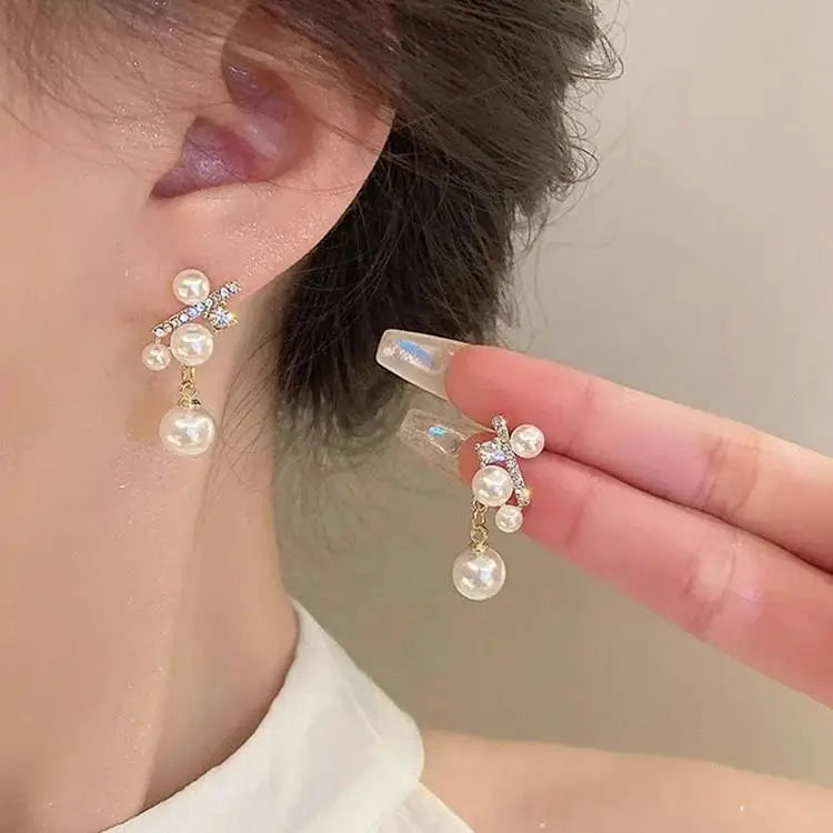Purple crystal heart drop earrings for women, elegant jewelry by Corporación Turística featuring dangling heart-shaped crystal pendants.