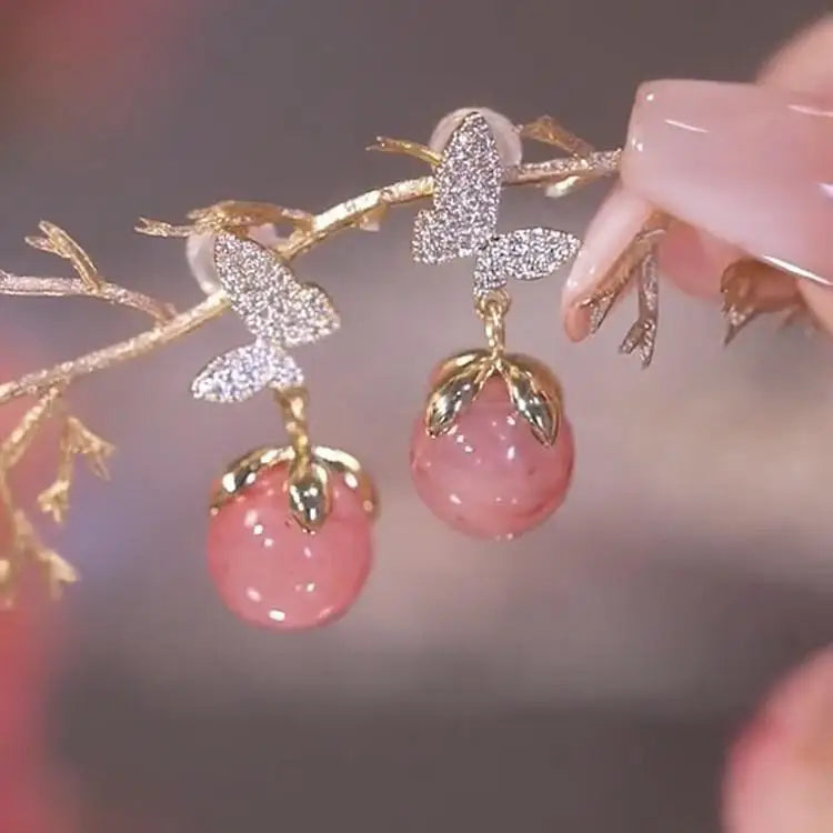 Purple crystal heart drop earrings for women featuring elegant dangling design, by Corporación Turística.