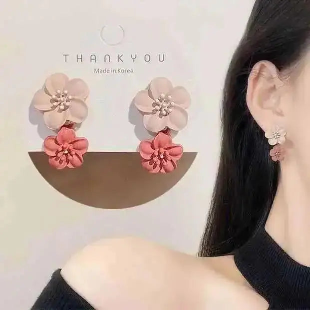 Purple crystal heart drop earrings for women, stylish jewelry by Corporación Turística, featuring elegant dangling crystal pendants.
