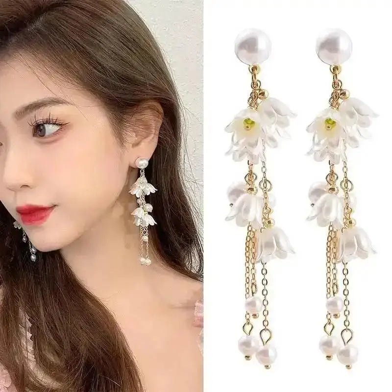 Korean fashion pearl tassel earrings with needle attachment, featuring white pearls and a sleek design for stylish wear.
