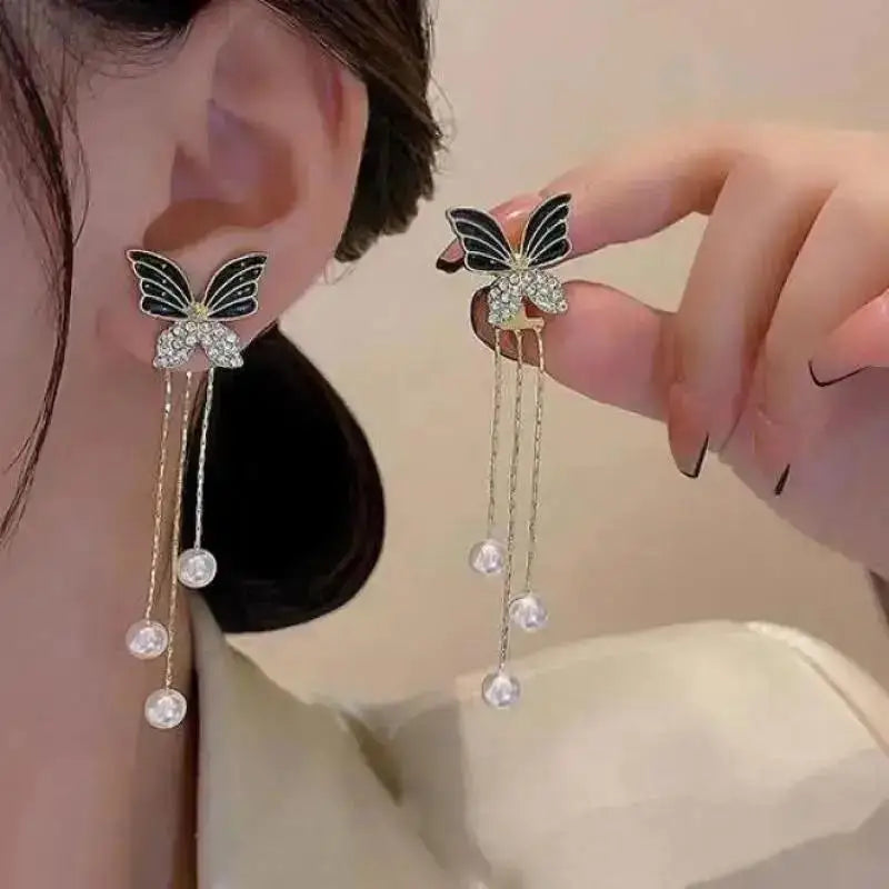 Korean fashion pearl tassel earrings with needle, featuring small white pearls and gold-tone accents, stylish and trendy jewelry.
