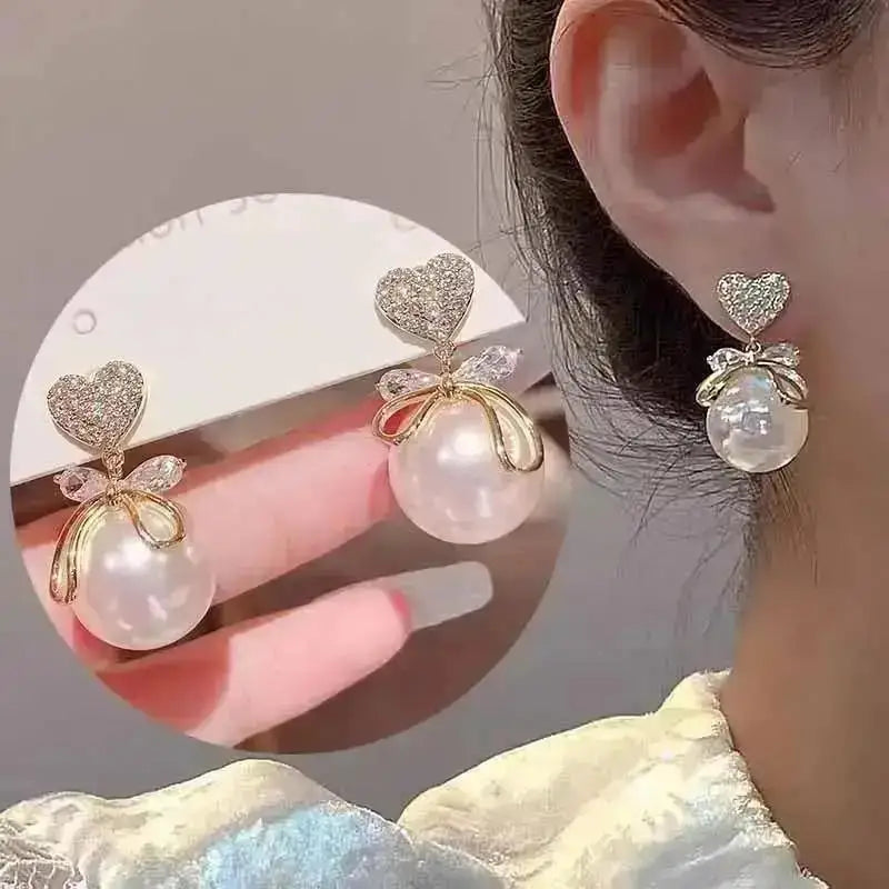 Korean fashion pearl tassel earrings with needle, featuring white beads and delicate dangle design by Corporación Turística.