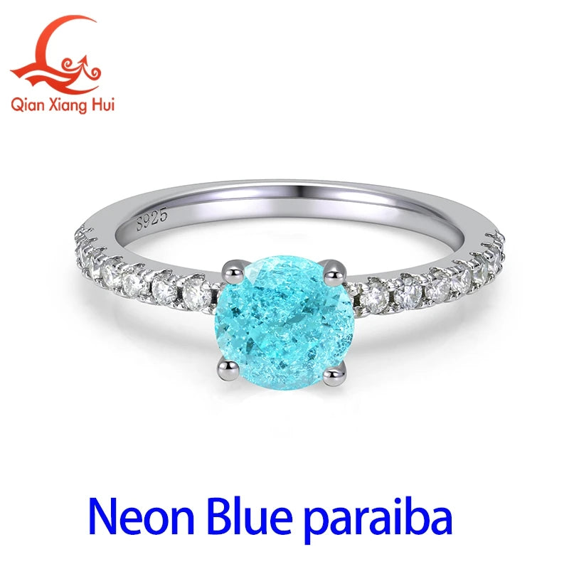 Silver ring featuring a 6.5mm neon blue-green Paraiba tourmaline and YAG gemstone for a vibrant, eye-catching jewelry piece.