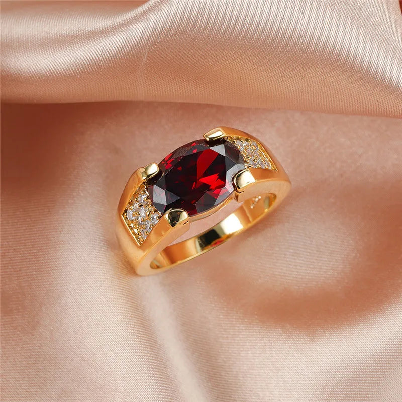 Luxury red crystal ring with oval zirconia, featuring a polished band and elegant design by Corporación Turística.