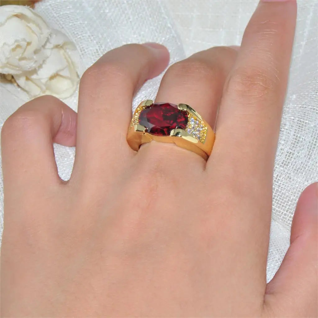 Elegant red crystal ring with oval zirconia, luxurious jewelry piece showcasing vibrant color and intricate design.