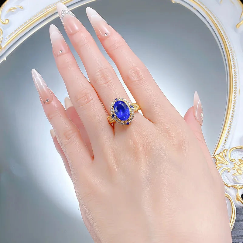Luxurious 24K gold solid ring with a blue gemstone, certified 9999 pure gold, featuring a decorative band design.