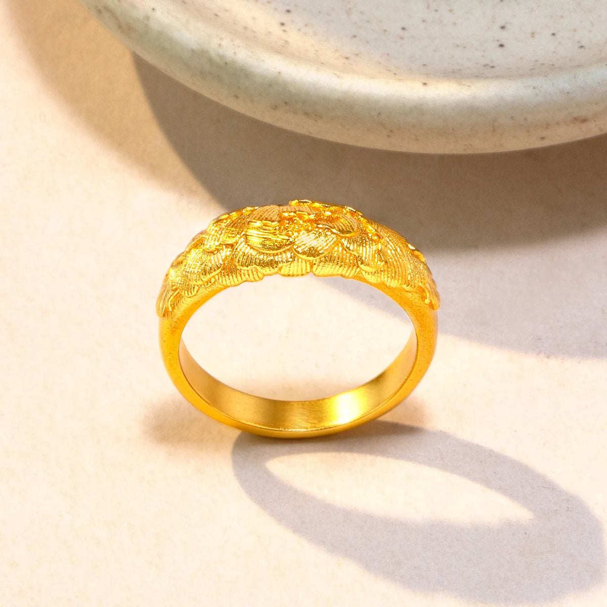 Gold solid ring with detailed peony relief for women, showcasing intricate floral design in a close-up image.