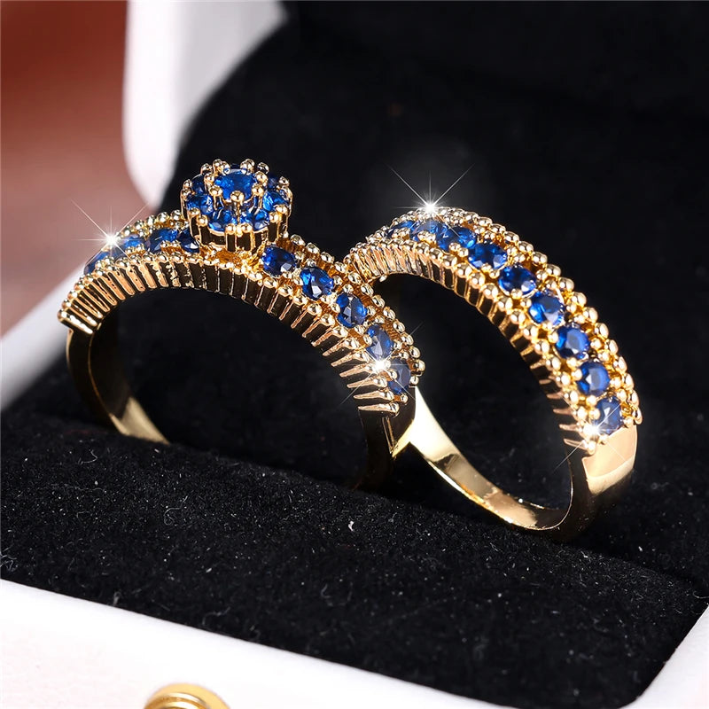 Set of zircon engagement rings from Corporación Turística featuring blue stones, displayed in a close-up image.