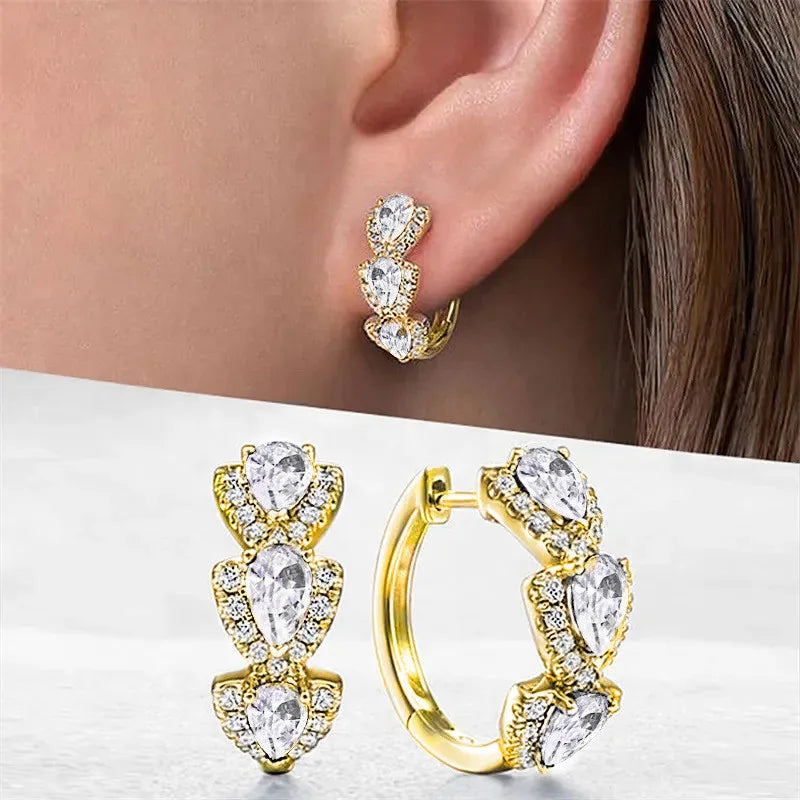 Sterling silver hoop earrings with cubic zirconia stones, stylish jewelry by Corporación Turística, shown in the image.
