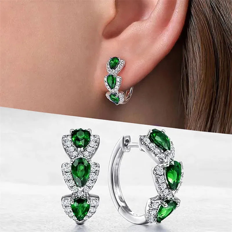 Sterling silver hoop earrings with cubic zirconia from Corporación Turística, showcasing shiny round design and sparkling stones.