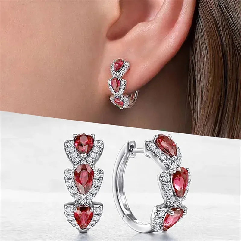 Blue cubic zirconia hoop earrings for women, featuring shiny round stones in silver-tone metal by Corporación Turística.