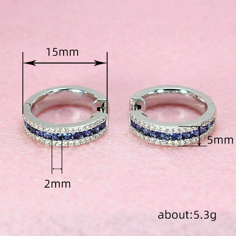 Sterling silver hoop earrings with cubic zirconia from Corporación Turística, showcasing shiny, elegant jewelry design.
