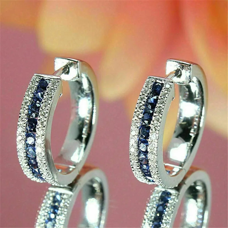 Sterling silver hoop earrings with cubic zirconia from Corporación Turística, featuring sparkling gemstone accents.