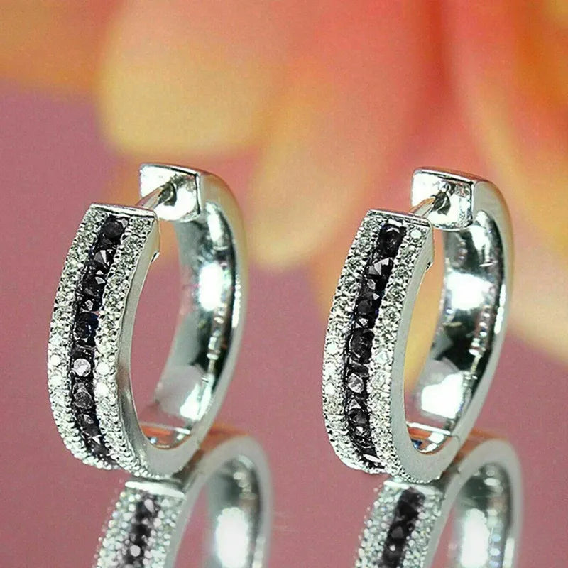 Sterling silver 925 hoop earrings with cubic zirconia by Corporación Turística, showcasing shiny, elegant jewelry design.