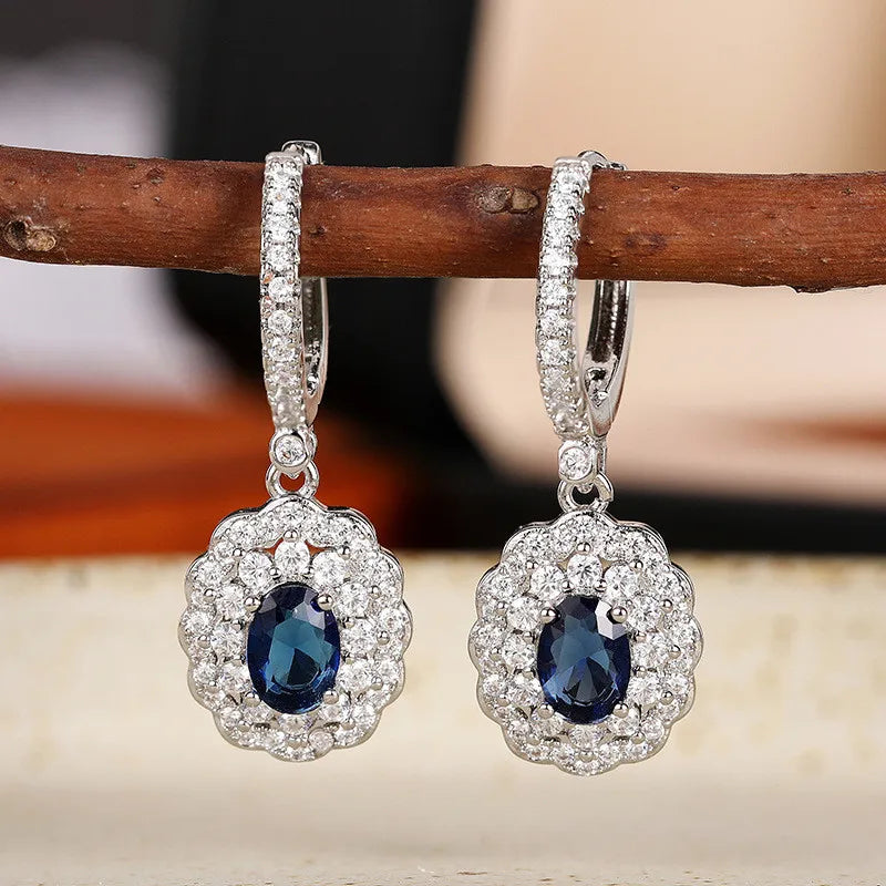 Sterling silver 925 pendant earrings with embedded stones, featuring elegant hanging design and intricate craftsmanship.