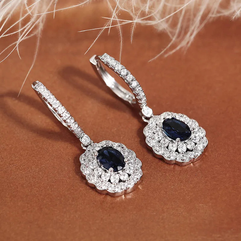 Silver 925 pendant earrings with embedded stones from Corporación Turística, featuring elegant hanging design.