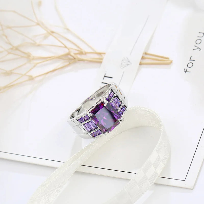 Wide purple cubic zirconia ring for women, elegant jewelry piece by Corporación Turística, showcasing a sparkling band.