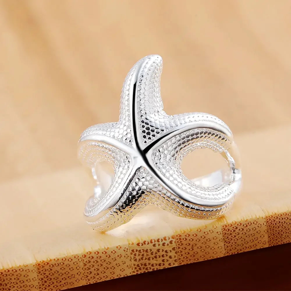 Large sterling silver starfish rings with fine detailing, featuring a sleek design and polished finish.