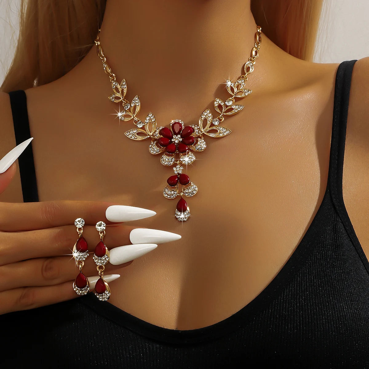 Silver floral jewelry set for women featuring a gold-tone necklace with flower designs, stylish and elegant.