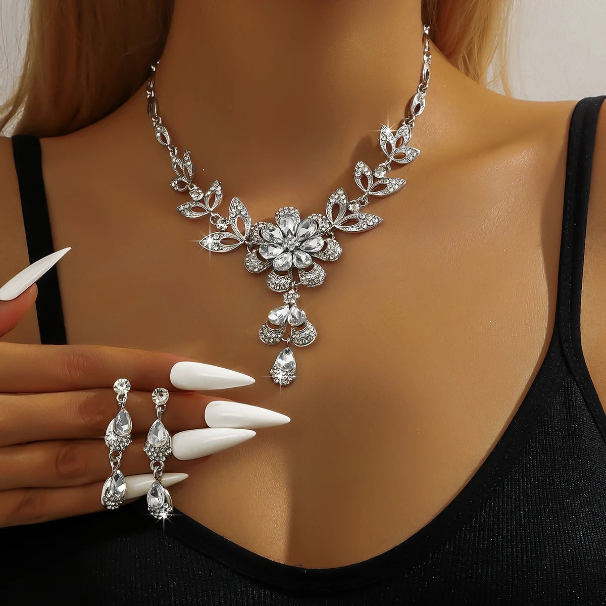 Silver jewelry set for women featuring a floral gold-tone necklace with matching earrings, elegant and stylish accessory.