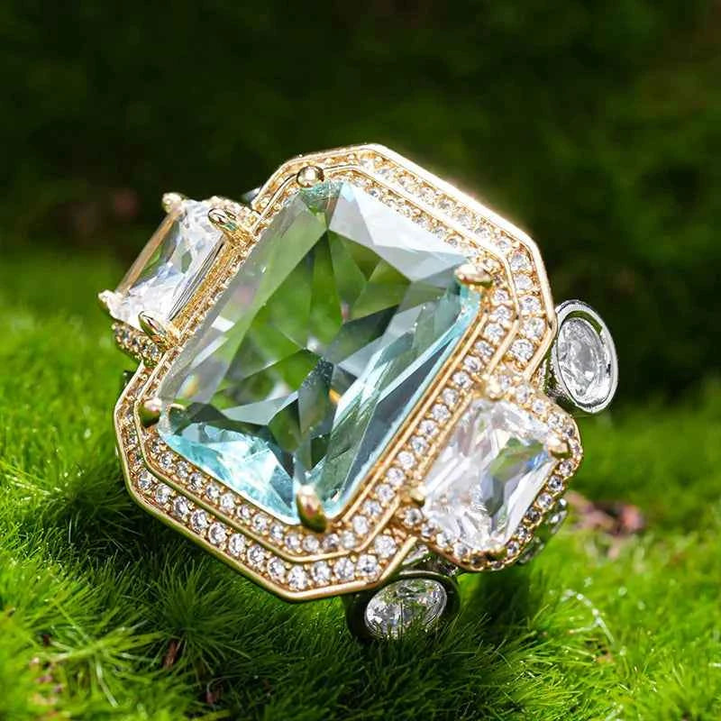 Blue cubic zirconia rectangular rings by Huitan, featuring elegant silver bands, showcased in a close-up image.