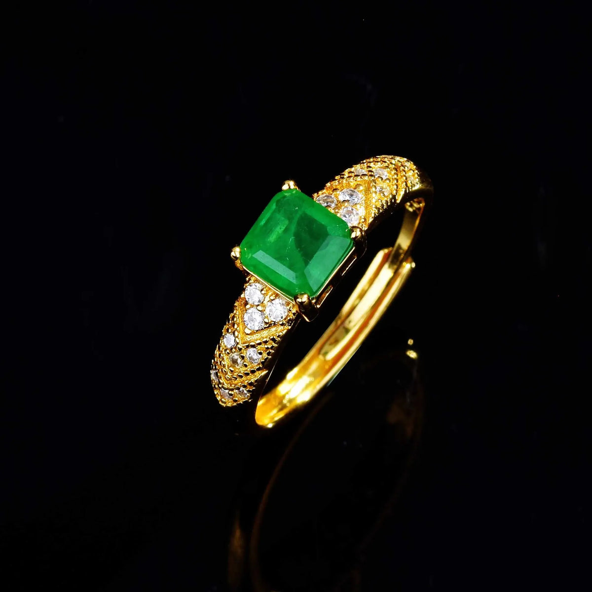 18K gold engagement ring for women with a natural emerald gemstone, featuring a sleek gold band and elegant design.